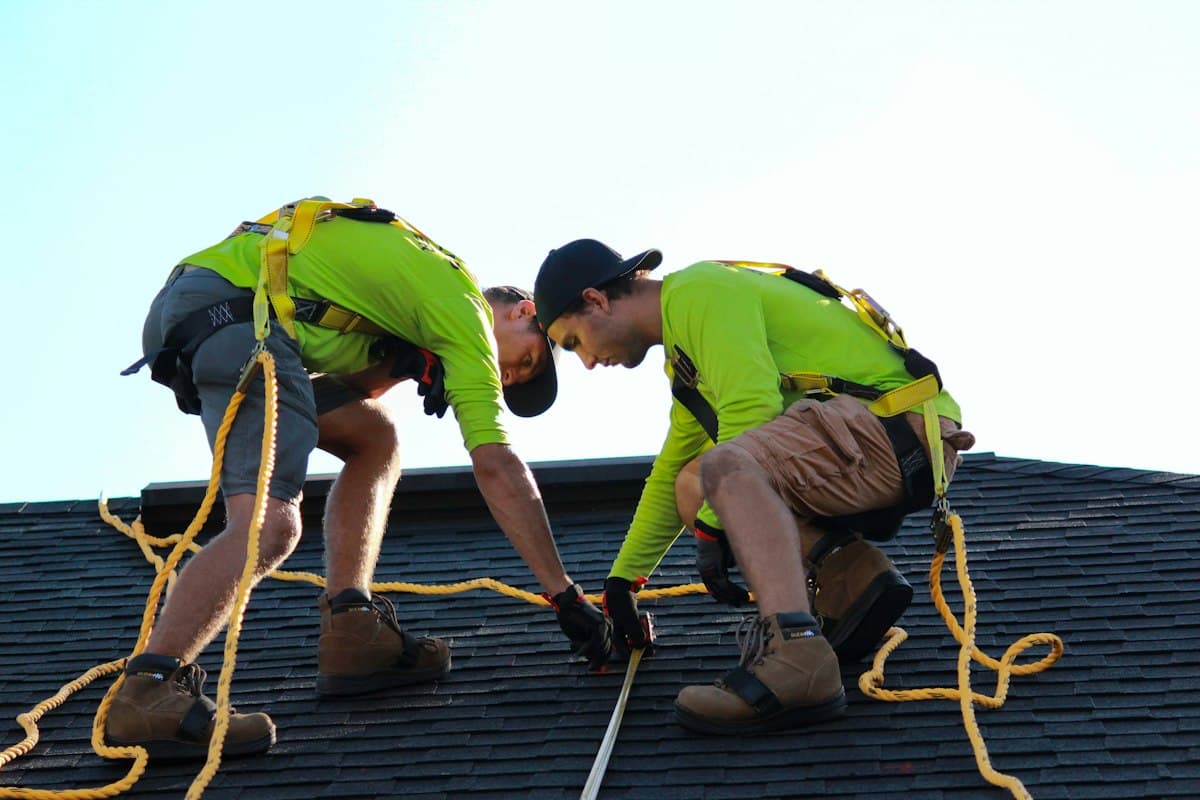Engineers installing solar panels on a commercial rooftop