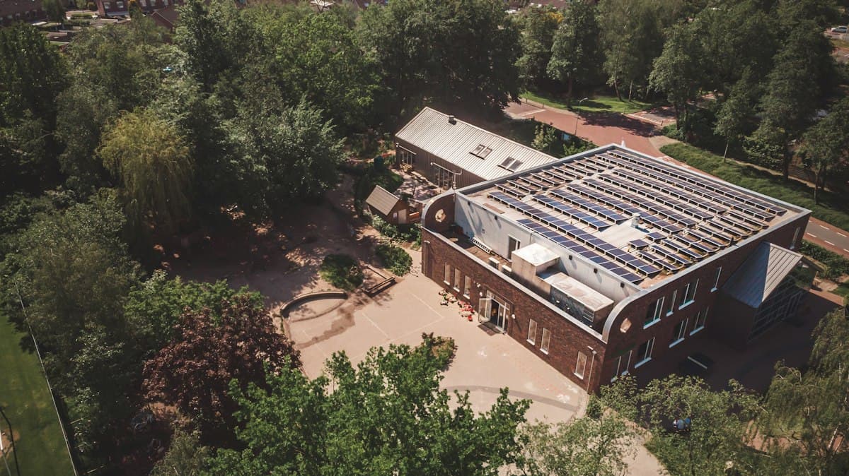 Aerial view of a commercial building rooftop covered with solar panels