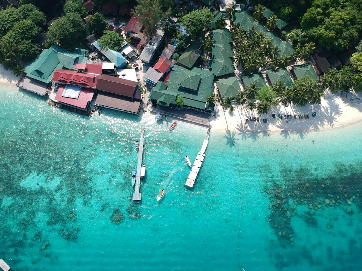 Aerial view of a tropical island resort surrounded by blue ocean